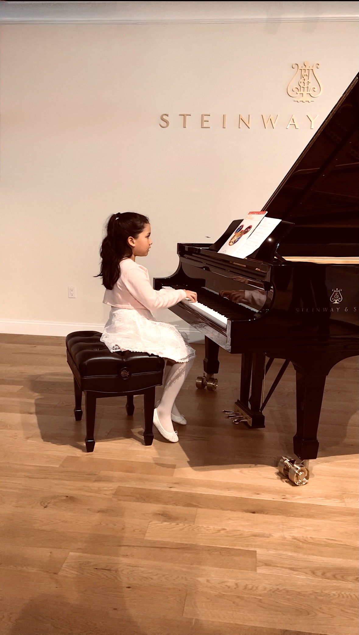 Students performing at a Steinway recital