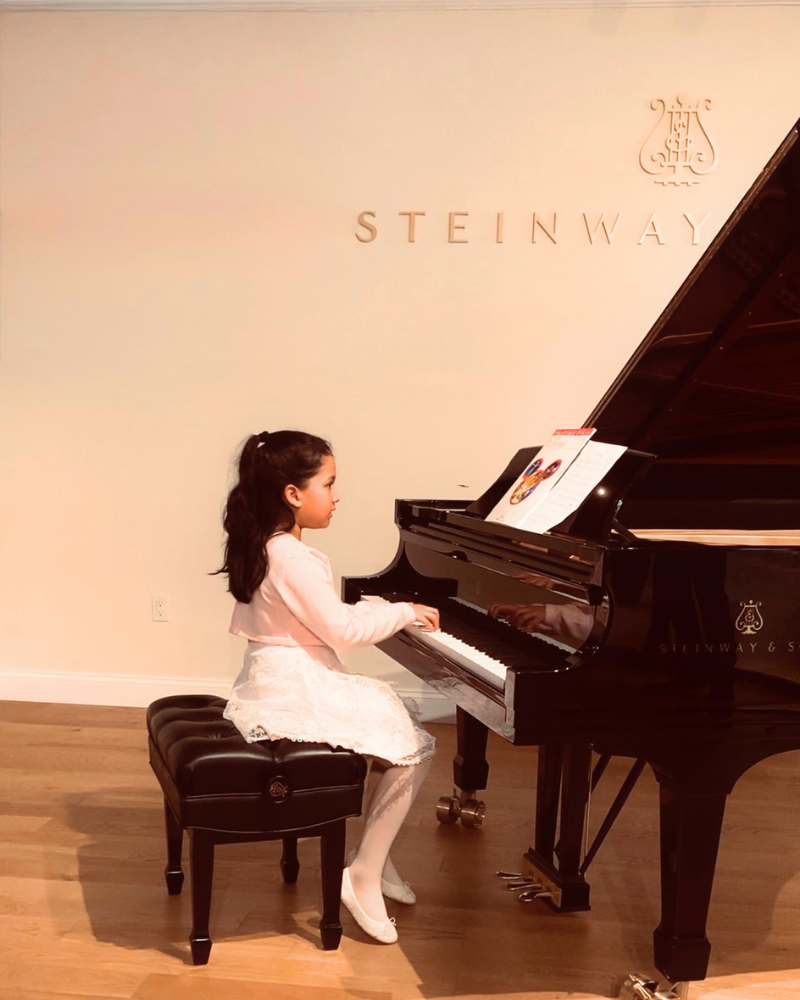 Students performing at a Steinway recital